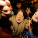 A family member of a passenger aboard Malaysia Airlines MH370 shouts at journalists in Beijing.
